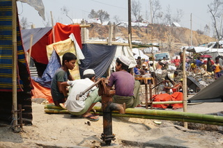 Rohingya boys rest after a fire broke out in the Rohingya refugee camps leaving 45k displaced overnight.