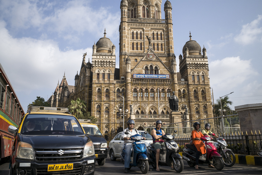 India. Maharashtra. Mumbai. Street traffic in front of Chatrapati Shivaji Terminus (CST), former Victoria Terminus. The historic train station is built by the British and has been in operation since 1888. CST is a UNESCO World Heritage Site in India and one of the landmarks of Mumbai. © Florian Lang