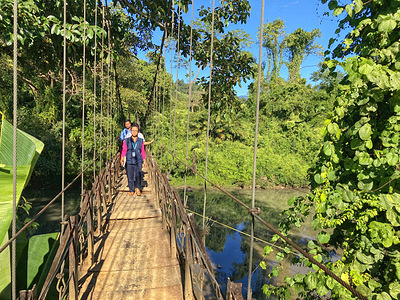   W HO National Public Health Support Network (NPSN) team crossing a suspension bridge across a river to conduct house-to-house visits to strengthen routine immunization in Lungpang village in Changlong district, Arunachal Pradesh, India.  WHO NSPN provides technical and monitoring support to strengthen routine immunization and vaccine-preventable diseases to the Government of I ndia with special focus on strengthening services in hard-to-reach areas. 