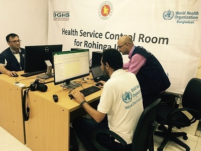 WHO launches the Control Room, a facility for health monitoring and early warning alerts in Cox’s Bazar district 20 September 2017. Cox’x Bazar. Directorate General of Health Services (DGHS) of MOHFW and World Health Organization (WHO) Representative to Bangladesh launched the Control Room, a facility that will help monitor the health issues from Rohingya settlements/camps. The Control Room will function under Cox’s Bazar Civil Surgeon’s office with support from WHO. The Control Room helps the Government of Bangladesh in strengthening the disease surveillance system and the daily reporting of morbidity and mortality reports from partners. This will enhance active monitoring of health situation, provide early warning alerts on outbreak prone diseases and will allow improved and efficient coordination of various health actors on the ground. The system is essential in management of health situation, as the population is very mobile, dispersed in 68 camps, and undocumented. In general, limited data are fully reliable regarding the health profile of the newly arrived population. The medical teams in the field are also operated by different actors, either public sector, International Organizations or NGO’s, making it difficult to coordinate and monitor overall health situation and services availability. The Control room will receive daily information from all the medical teams irrespective of who operates them, will analyze it and will provide conclusive assessments to the public authorities to make informed decisions on further actions. The system is part of WHO’s response in supporting the Government of Bangladesh to lead the humanitarian health response required to address the needs of the recent influx of over 400.000 Rohingyan migrants from Myanmar in less than a month. WHO is committed to ensure effective coordination is in place at the field level, in collaboration with other UN agencies, IOM, UNFPA, UNHCR and UNICEF as well as NGO partners involved in this effort.