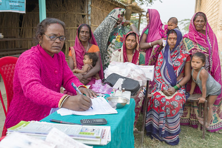 Martha Dodray, a health worker, prepares an immunization session in Tilkeshwar village in the remote Kosi River Basin area of Bihar State. The effort to end polio in the area resulted in improved access to the area for health workers like Martha, closer relations with the communities, and more demand for immunization. Kosi River Basin area near Darbhanga, Bihar State, India. November 2017.