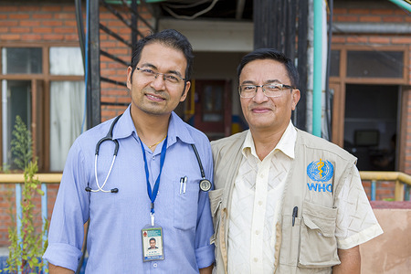 Dr. Shakya Sagar, a WHO Surveillance Medical Officer, stands with Dr. Dhruba Shrestha, a pediatrician at the Siddhi Memorial Hospital in Baktapur in the Kathmandu Valley. If Dr. Shrestha suspects a child has a vaccine-preventable disease such as polio or measles, he calls Dr. Sagar, who would investigate the child and report the case. This surveiillance is critical to confirming the presence, or absence of diseases like polio and measles. Bhaktapur, Nepal. August 2019.