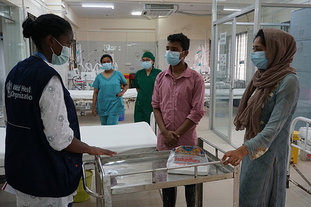 WHO Infection Prevention and Control Specialist, Rebecca Rachel Apolot, talking with the IPC Focal point of 250 Bed District Sadar Hospital Intensive Care Unit